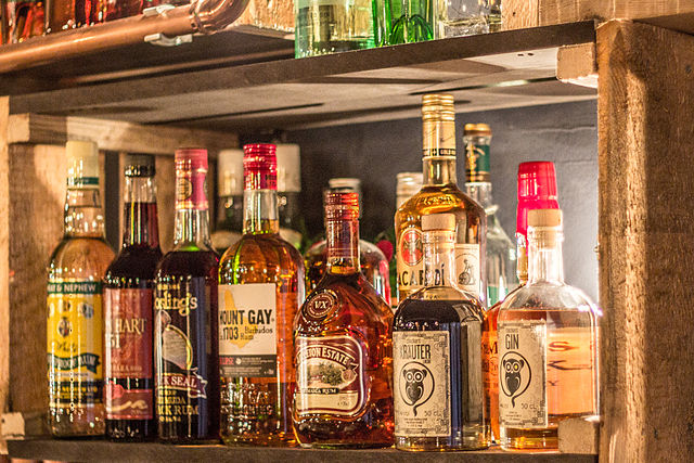 Backbar with various bottles of rum and other spirits Bar Kleines Phi, Hamburg
